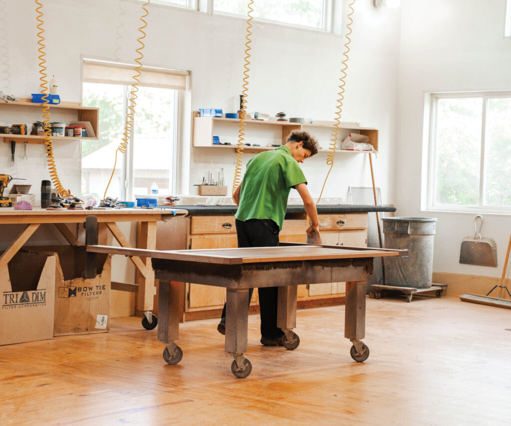 Builder Feature for Brookside Home Furnishings with craftsman working in furniture workshop.
